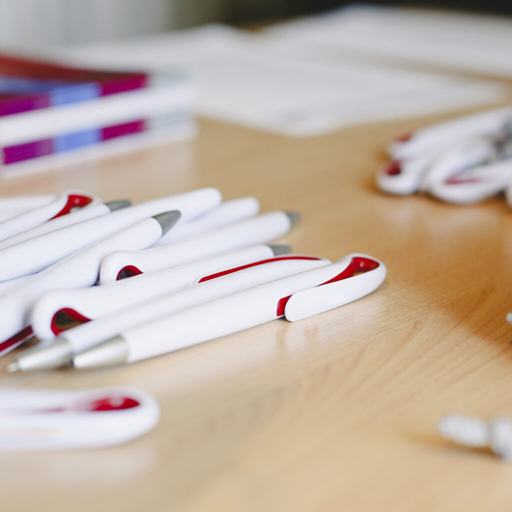 Pile of unbranded pens that are going to be customized with a logo.